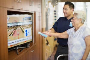 Nurse and Resident at Midtown Oaks Rehab gym Wii console