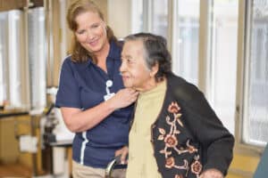 Nurse with resident at the Midtown Oaks rehab gym