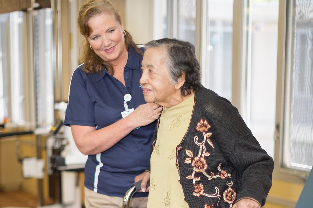 Nurse with resident at the Midtown Oaks rehab gym